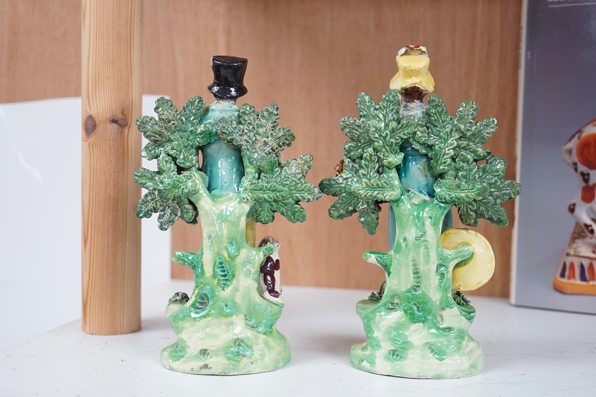 A pair of early 19th century pearlware figures of a huntsman and a female archer, 19.5cm high. Condition - some restoration otherwise in reasonable condition